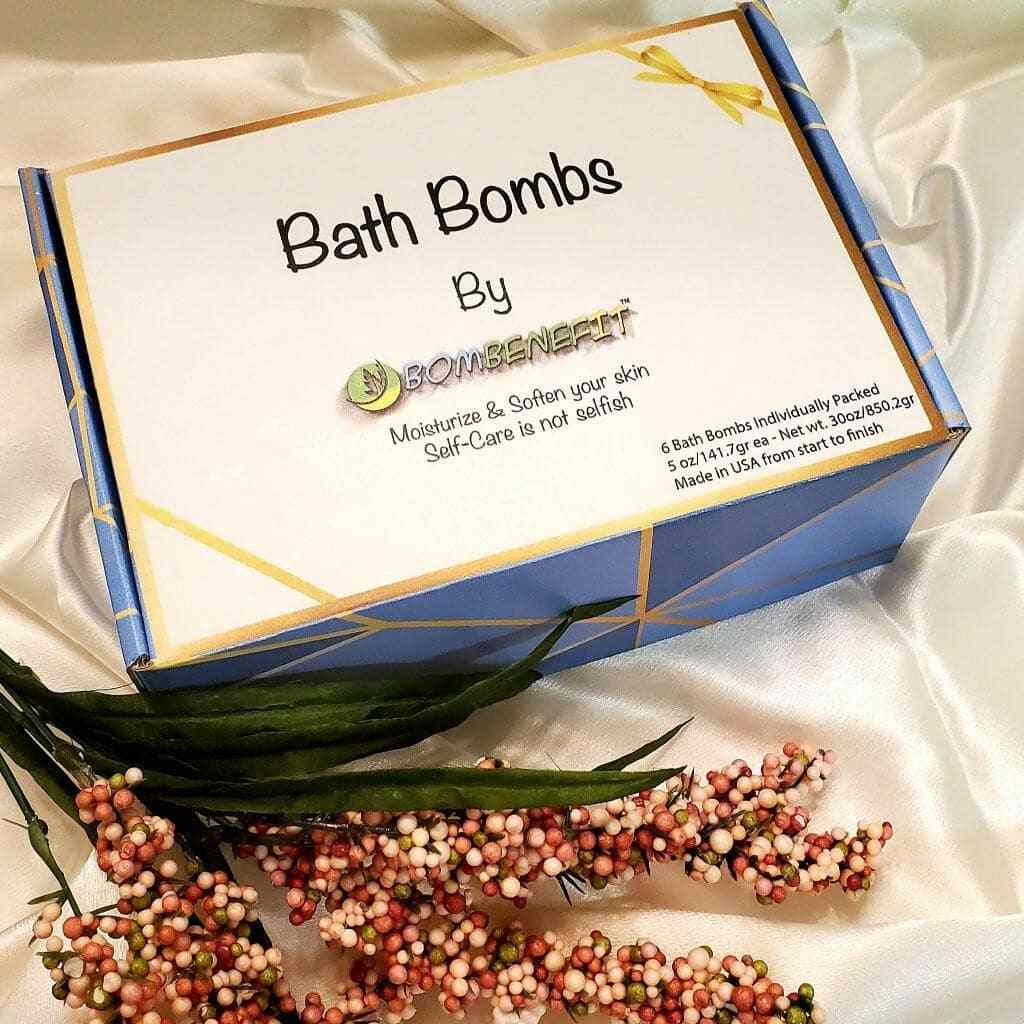 Bath Bombs by Bombenefit gift set box on silk fabric with decorative flowers. Ideal self-care gift, moisturizes, and softens skin.