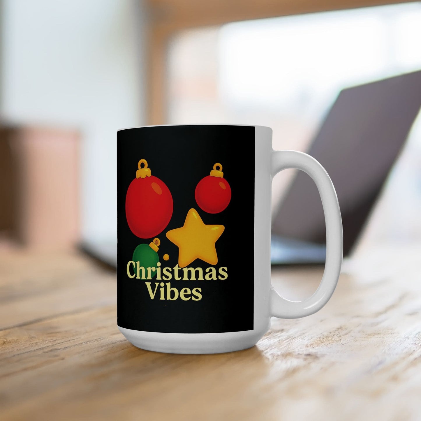 White ceramic mug with red and green ornaments, yellow star, and "Christmas Vibes" text on black background.
