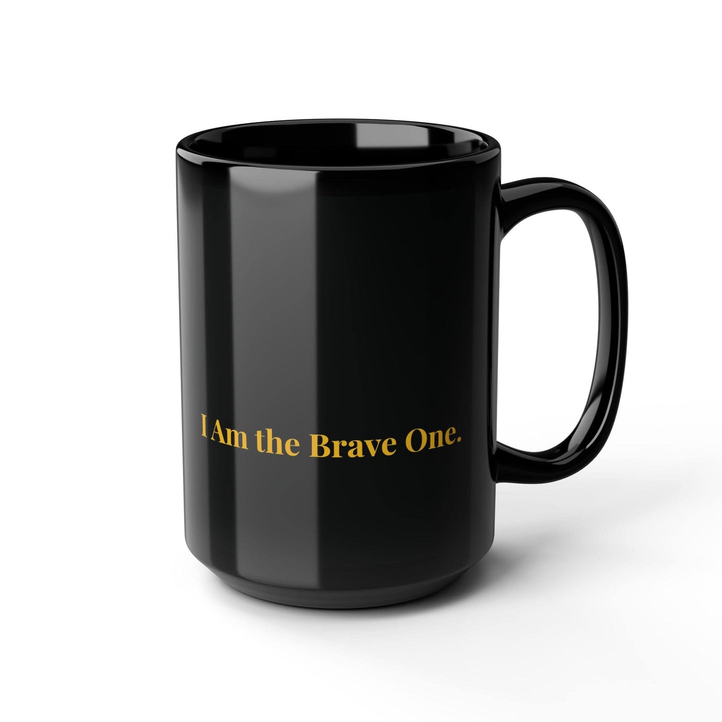 Black ceramic mug with gold "I Am the Brave One" text, displayed on a plain white background for a clean and minimalist product view.