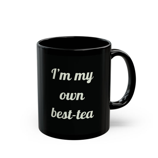 Black ceramic mug with the quote “I’m my own best-tea” in white script font, perfect for tea lovers and self-love gifts.