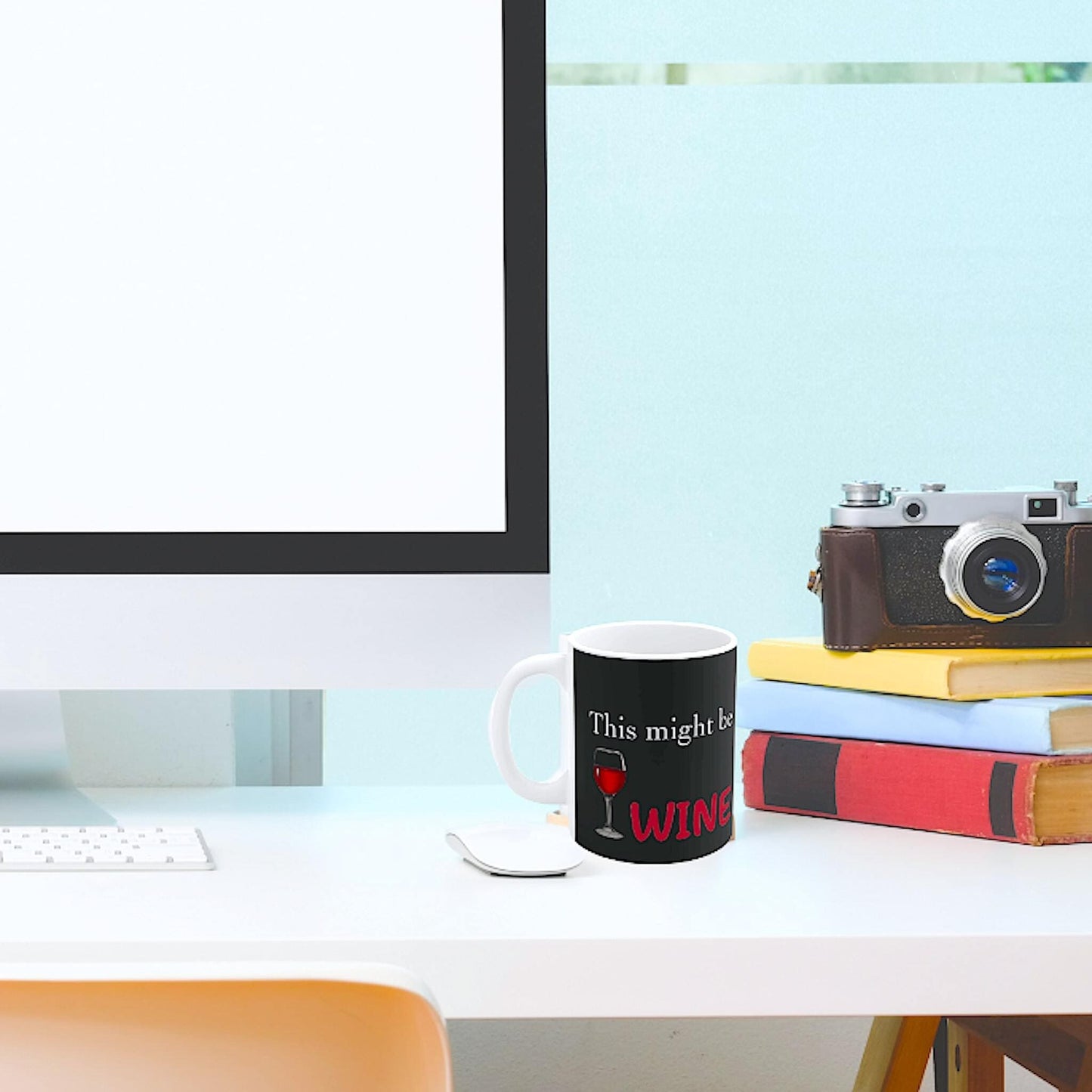 Black coffee mug on desk with the phrase 'This might be WINE' in a modern home office setup, perfect gift for wine lovers
