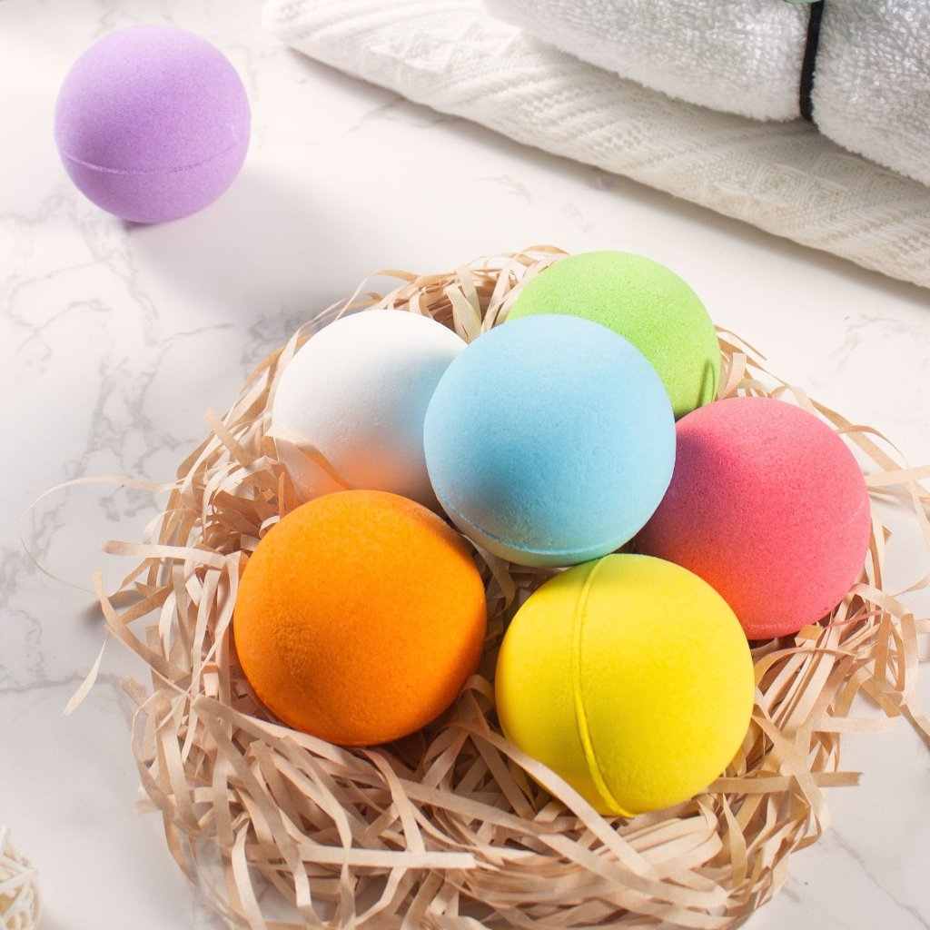 Colorful bath bomb set in a natural basket for a relaxing spa experience, featuring vibrant orange, pink, green, and blue bombs.