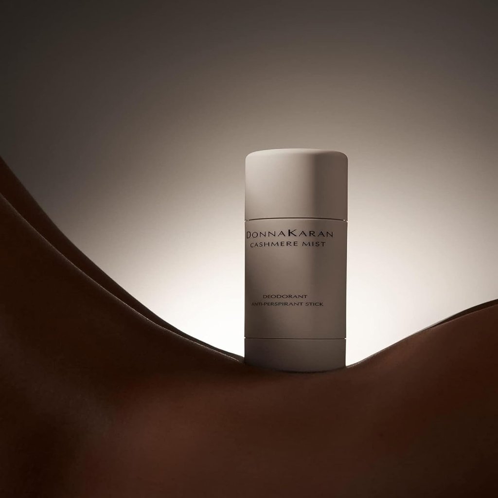 Donna Karan Cashmere Mist deodorant stick illuminates a curved, sculptural body, highlighting its elegance.
