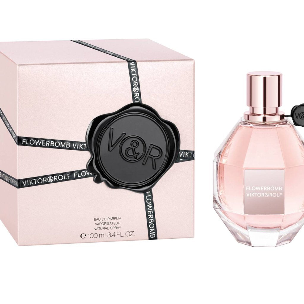 Flowerbomb Eau De Parfum by Viktor & Rolf in luxurious pink diamond bottle with black seal, presented next to elegant packaging.
