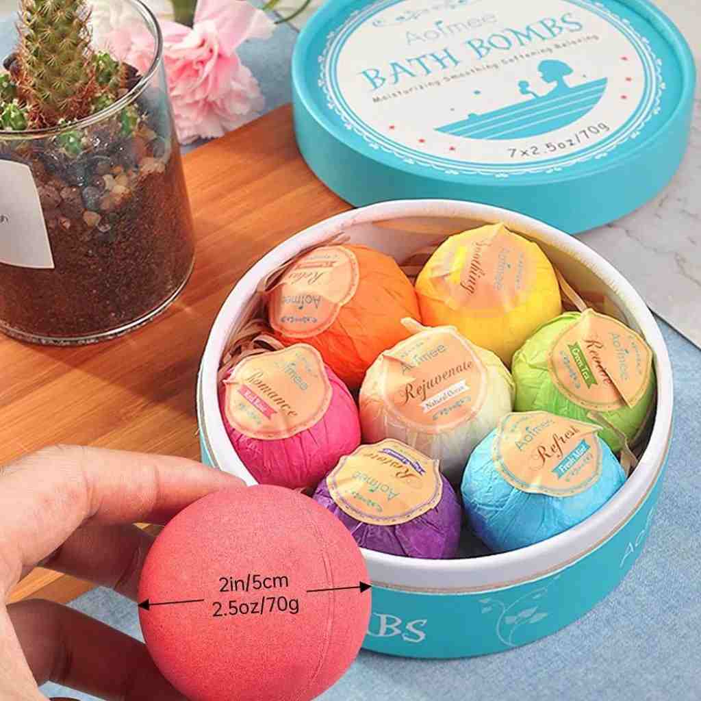 Colorful bath bomb gift set in a decorative blue box with a ribbon, featuring six scents for relaxation, rejuvenation, and romance
