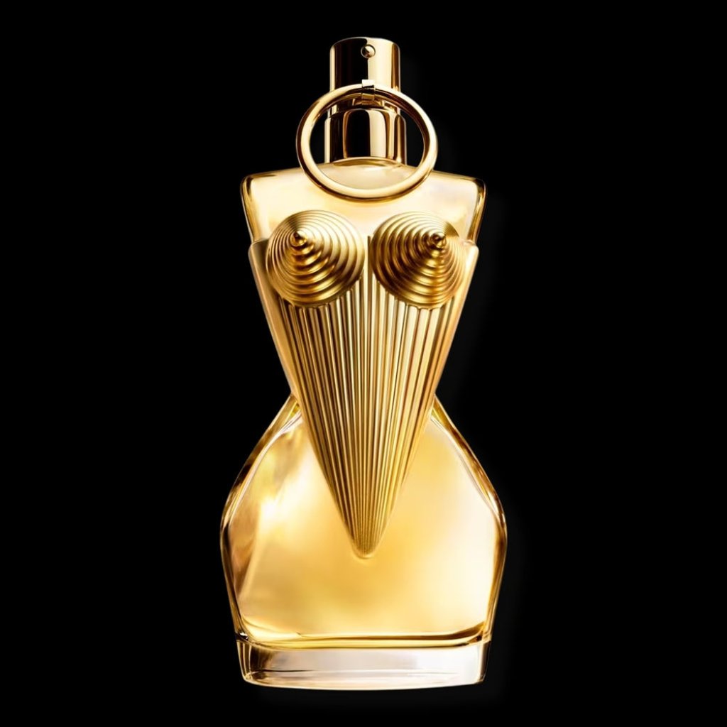 Close-up of Jean Paul Gaultier's Divine perfume bottle, showcasing a gold corset design with intricate sculpted details on black.
