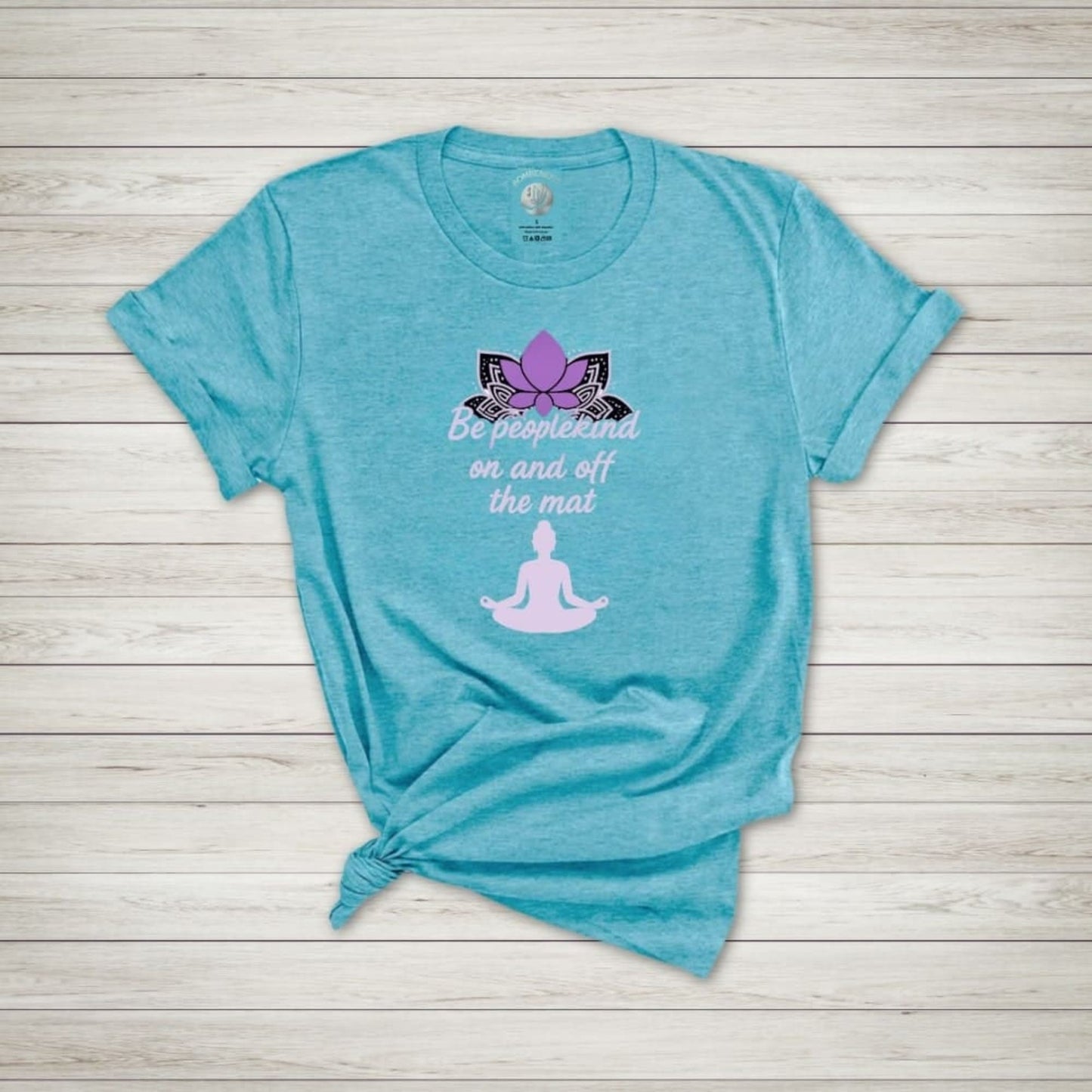 Heather Aqua yoga shirt with purple lotus, "Be peoplekind on and off the mat" quote, and meditating silhouette design
