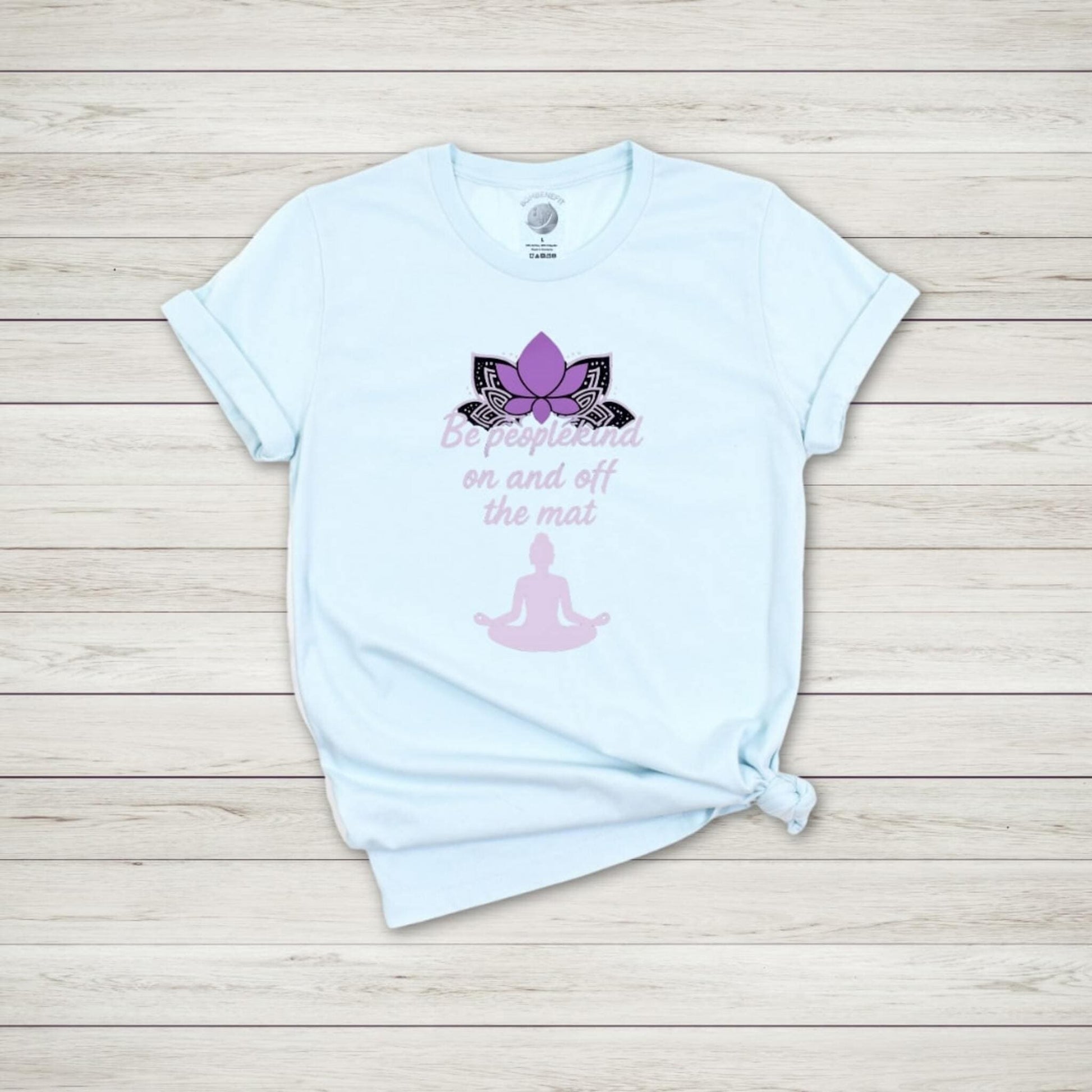 Heather Ice Blue yoga shirt with purple lotus and meditating figure, "Be peoplekind on and off the mat" quote design