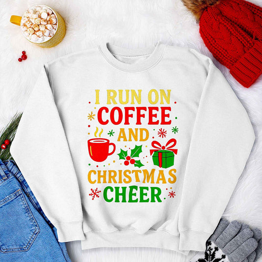 White Christmas sweatshirt with colorful “I run on coffee and Christmas cheer” design, featuring coffee mug, gift, and holly. Cozy unisex holiday sweater gift idea.