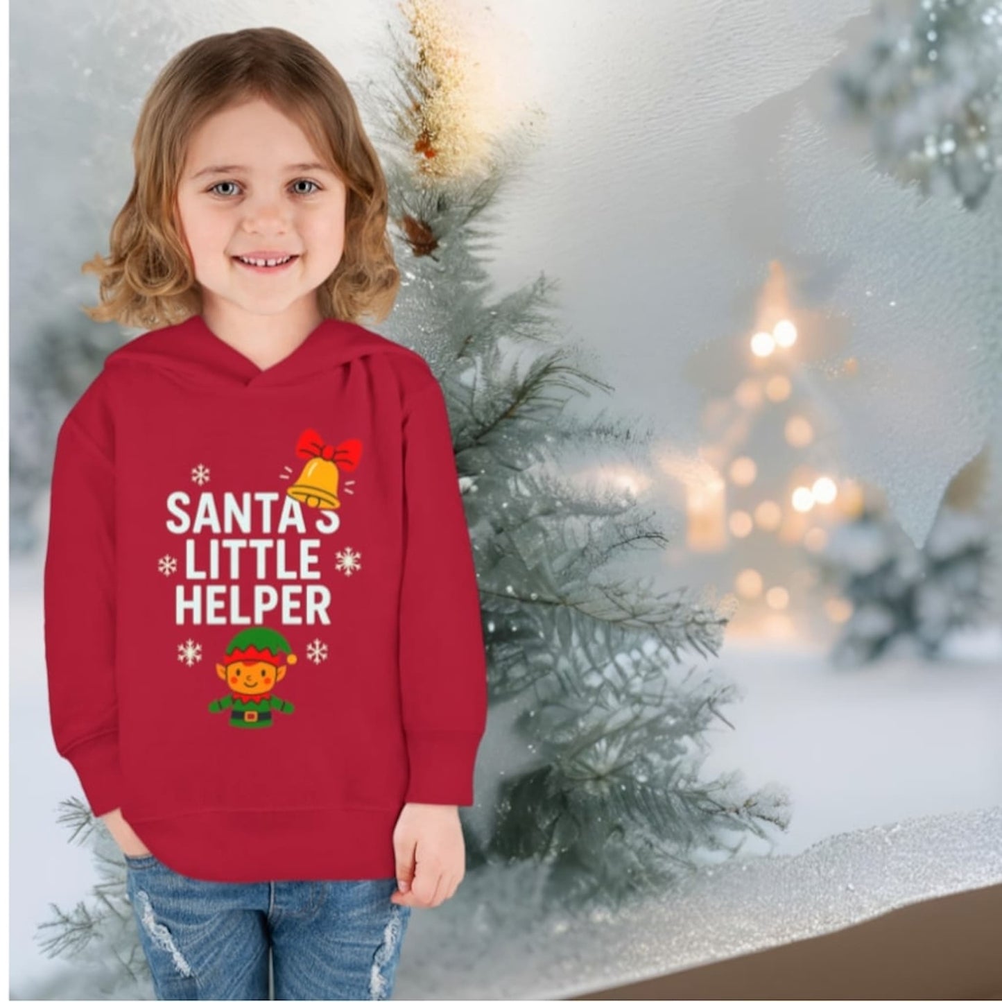 Child wearing red Santa’s Little Helper Christmas hoodie with cute elf design.
