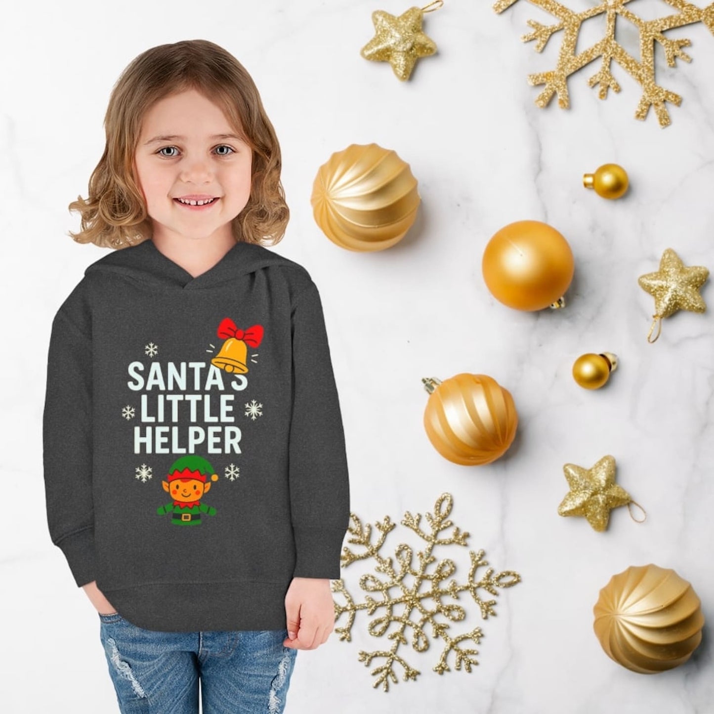 Child wearing vintage smoke hoodie with Santa’s Little Helper design, featuring elf, bell, and snowflakes, cute Christmas outfit.