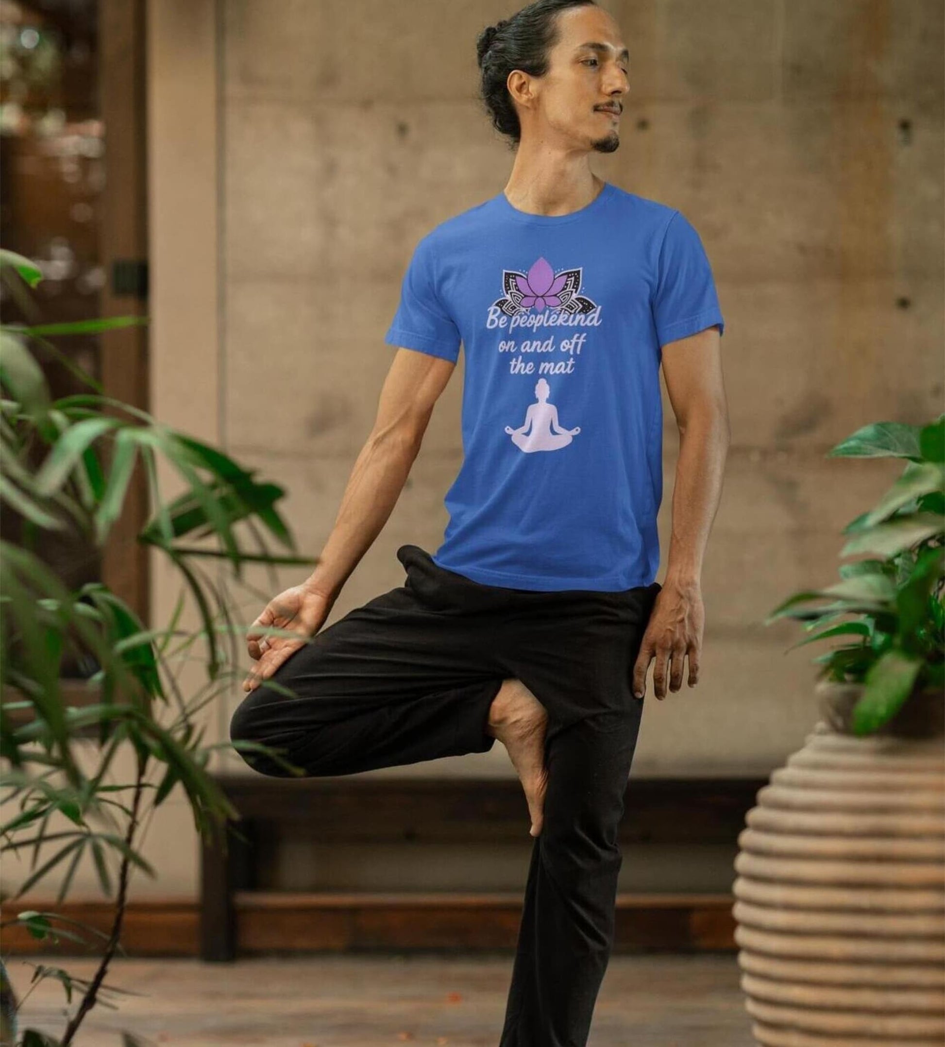 True Royal Bella Canvas 3001 yoga t-shirt worn by man in tree pose, with lotus and Be peoplekind on and off the mat quote